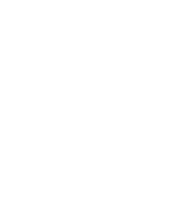 Photographer arranging framed images for an exhibition mock-up beside measuring tape and notes